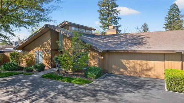 a view of an empty room with a fireplace and a window
