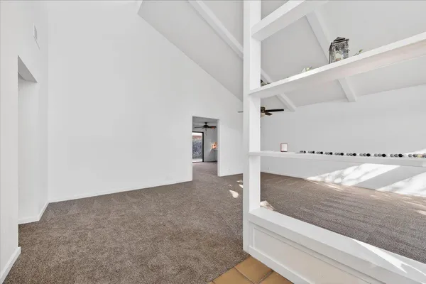 a view of a livingroom with a fireplace and window