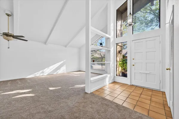 a view of empty room with a fireplace and window