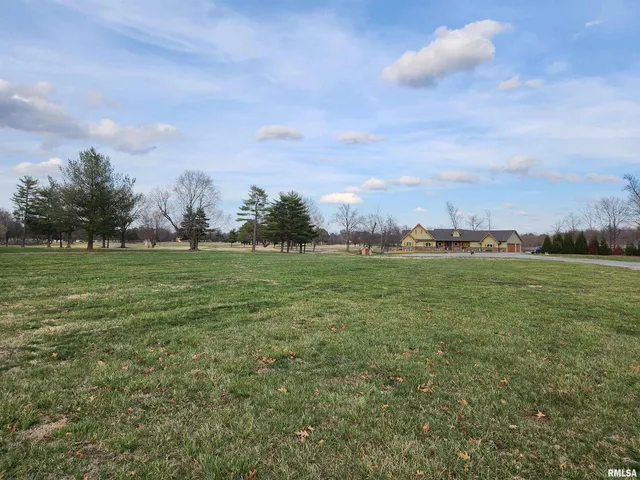 a view of a field with sitting area