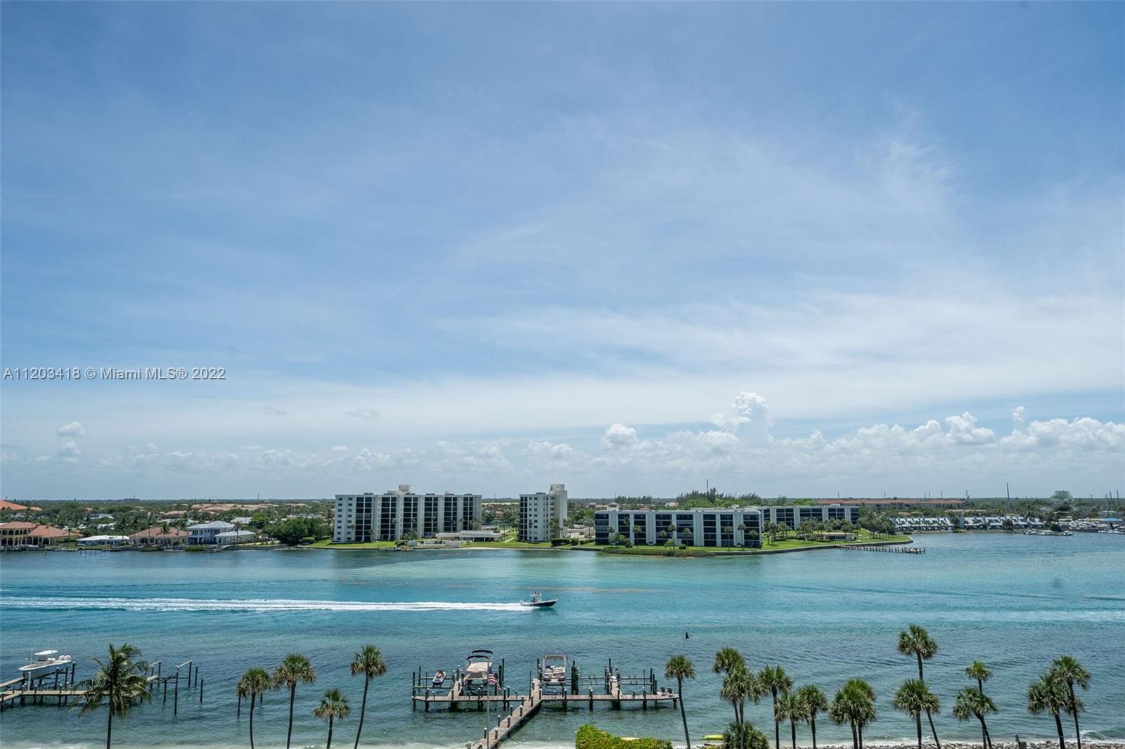 19900 South Beach Road, Unit 303 Jupiter, FL 33469 - Photo 3 of 6 a view of a lake with houses in the back