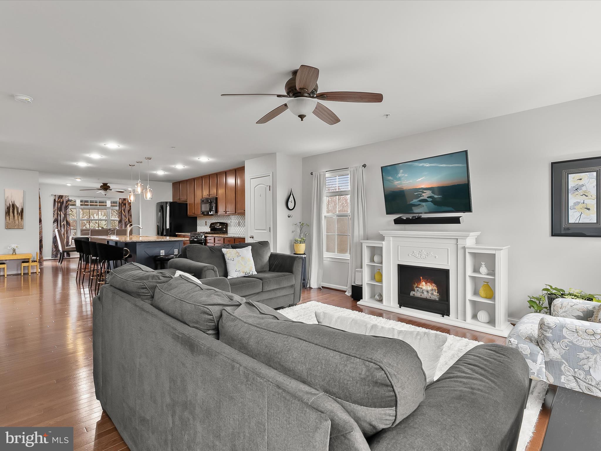 1410 Wellspring Drive Aberdeen, MD 21001 - Photo 12 of 55 a living room with furniture a fireplace and a flat screen tv