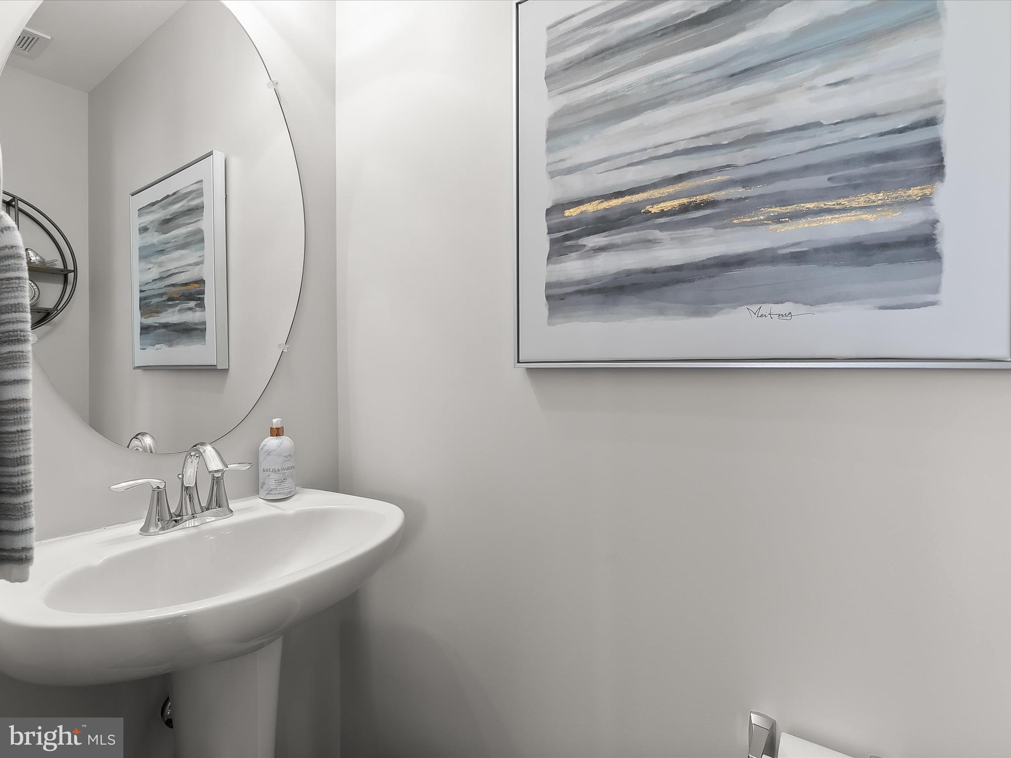 1410 Wellspring Drive Aberdeen, MD 21001 - Photo 13 of 55 a bathroom with a sink and a mirror