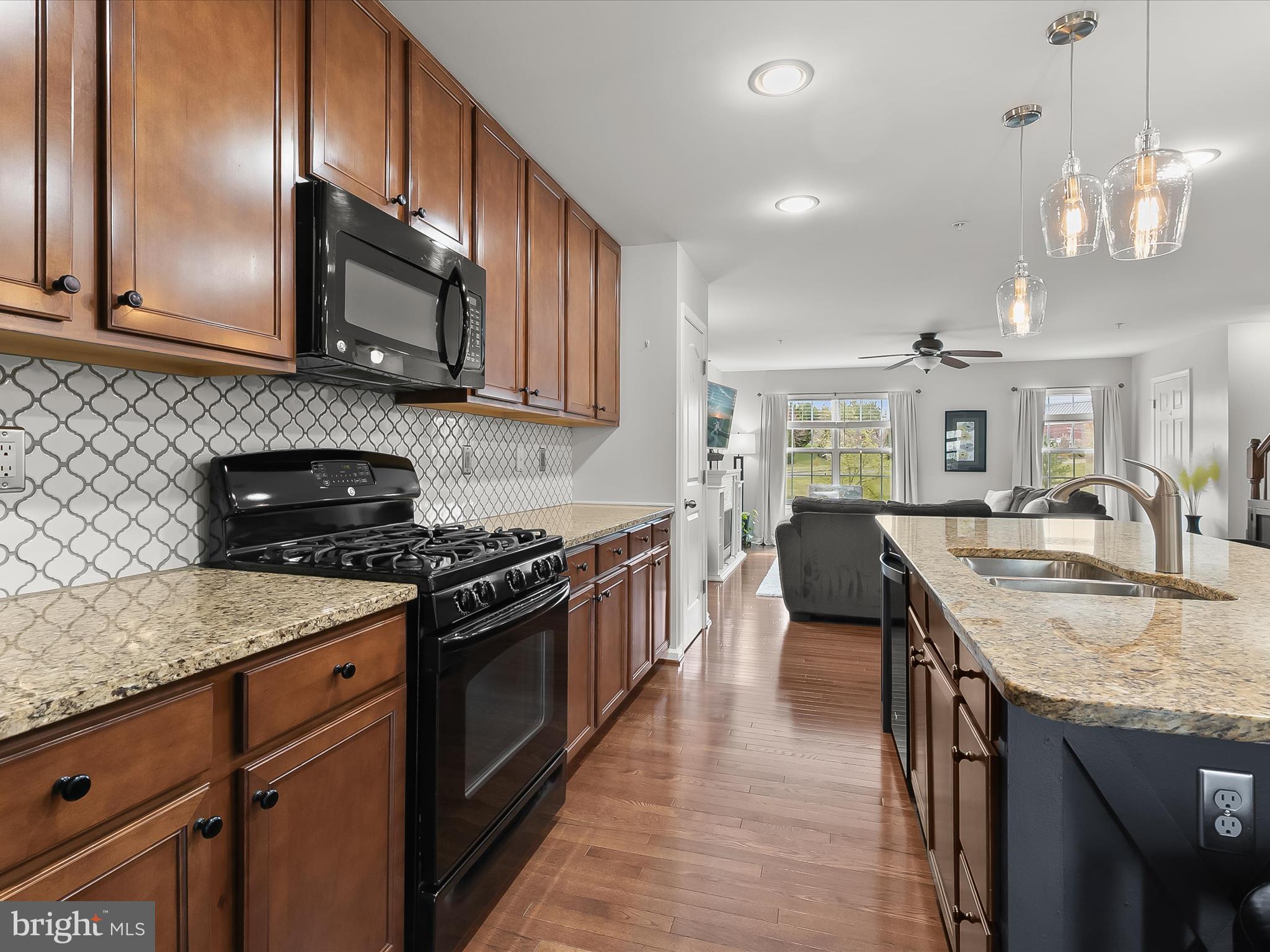 1410 Wellspring Drive Aberdeen, MD 21001 - Photo 16 of 55 a kitchen with stainless steel appliances granite countertop a stove and a sink