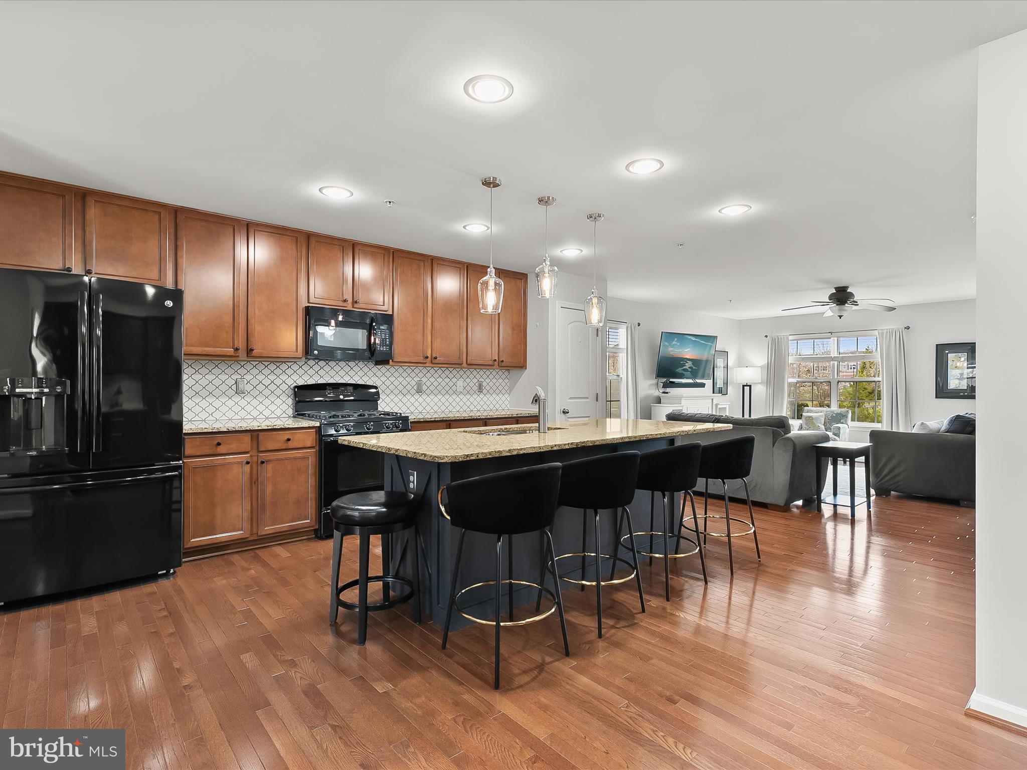 1410 Wellspring Drive Aberdeen, MD 21001 - Photo 17 of 55 a kitchen with a dining table chairs appliances and a center island