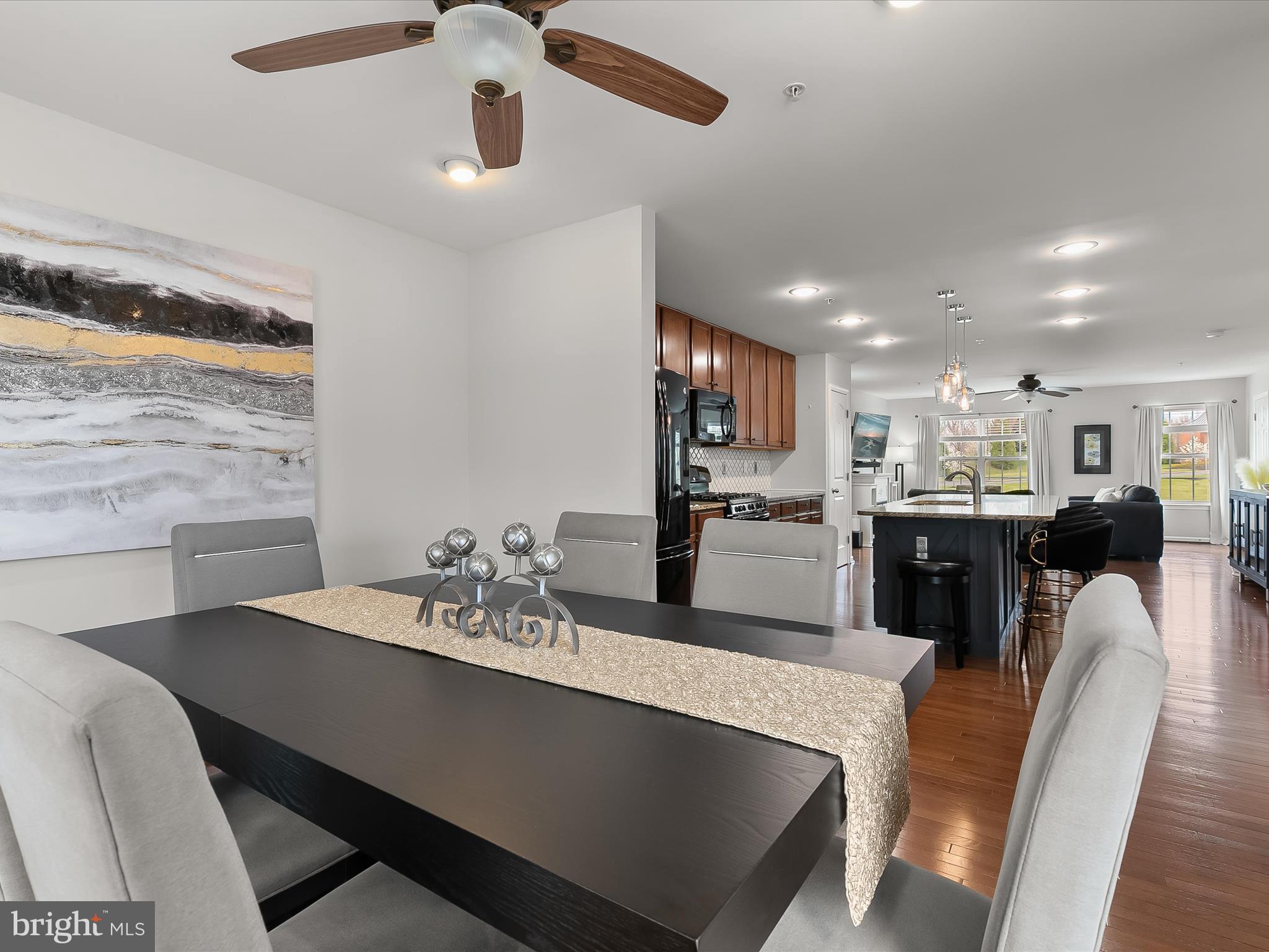 1410 Wellspring Drive Aberdeen, MD 21001 - Photo 19 of 55 a kitchen with stainless steel appliances kitchen island granite countertop a sink and chairs