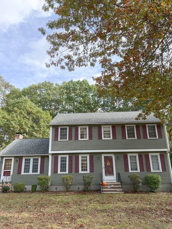 a front view of a residential houses with yard