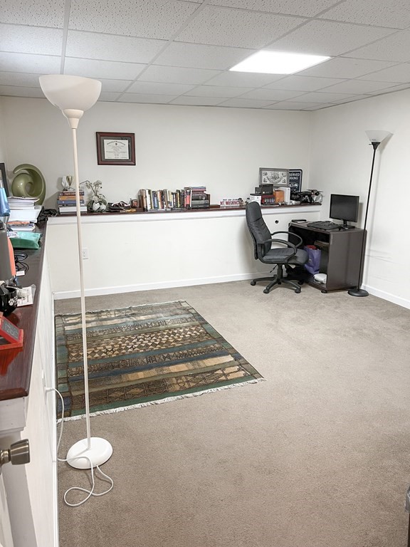 35 Robert Road Tyngsborough, MA 01879 - Photo 11 of 25 a room with gym equipment and a chandelier