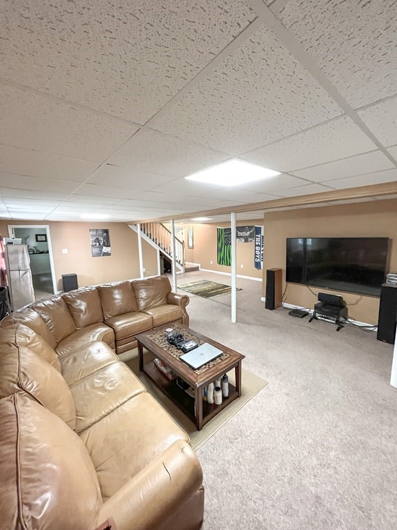 35 Robert Road Tyngsborough, MA 01879 - Photo 13 of 25 a living room with furniture a flat screen tv and a table