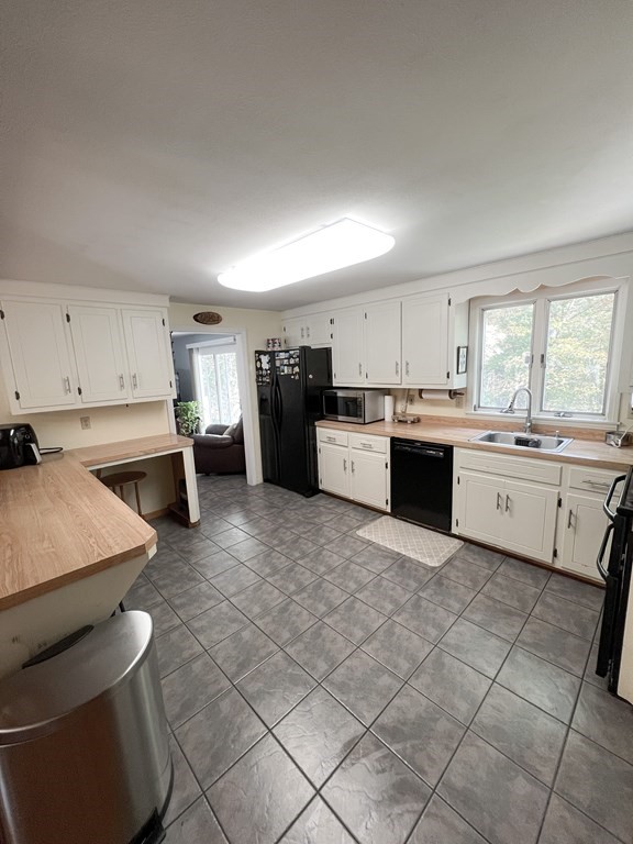 35 Robert Road Tyngsborough, MA 01879 - Photo 15 of 25 a kitchen with a sink a stove a refrigerator and cabinets