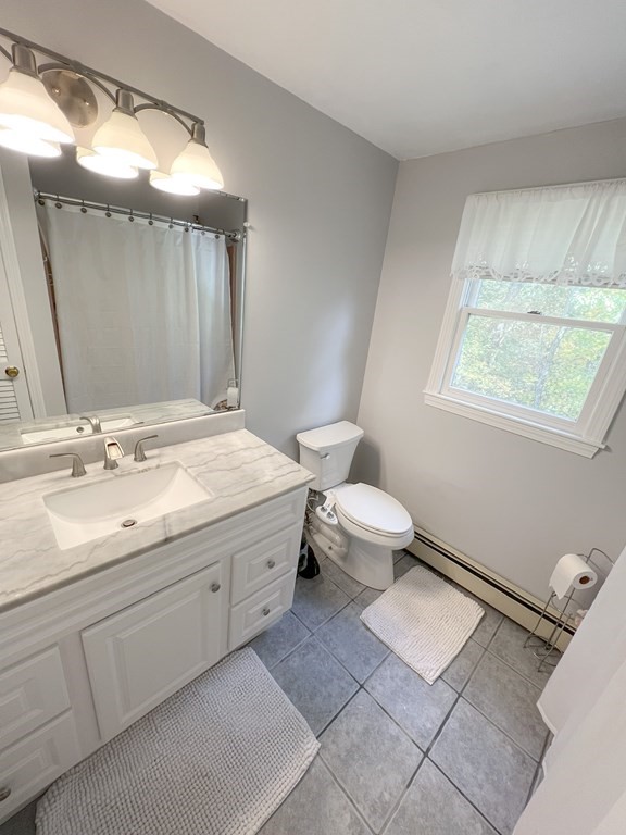 35 Robert Road Tyngsborough, MA 01879 - Photo 18 of 25 a spacious bathroom with a double vanity sink toilet and a mirror
