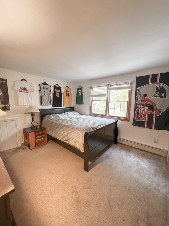35 Robert Road Tyngsborough, MA 01879 - Photo 21 of 25 a spacious bedroom with a bed and a large window