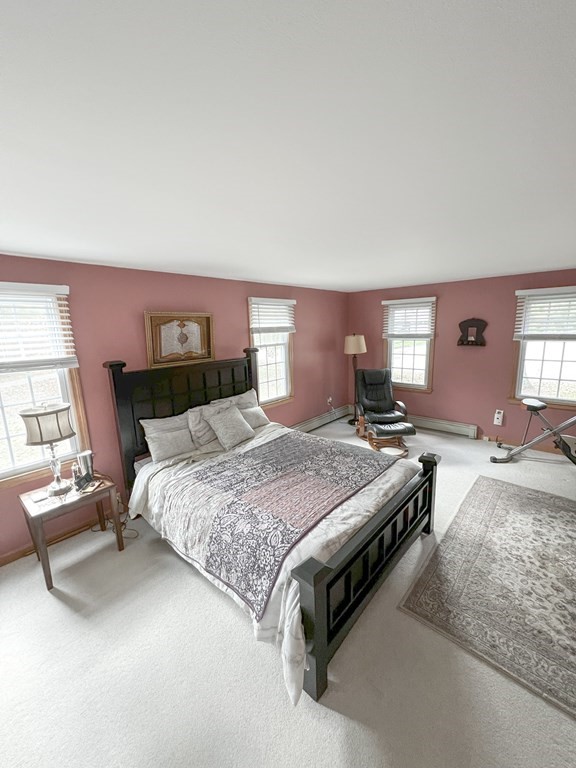 35 Robert Road Tyngsborough, MA 01879 - Photo 24 of 25 a spacious bedroom with a bed and large windows