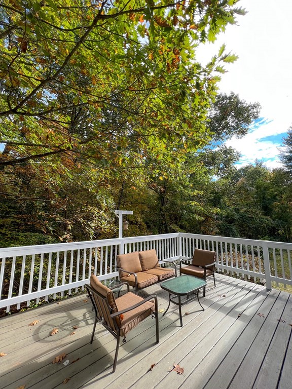 35 Robert Road Tyngsborough, MA 01879 - Photo 5 of 25 a view of a wooden deck with a bench