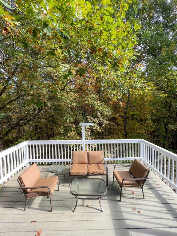 35 Robert Road Tyngsborough, MA 01879 - Photo 6 of 25 a view of a chair and table on the deck