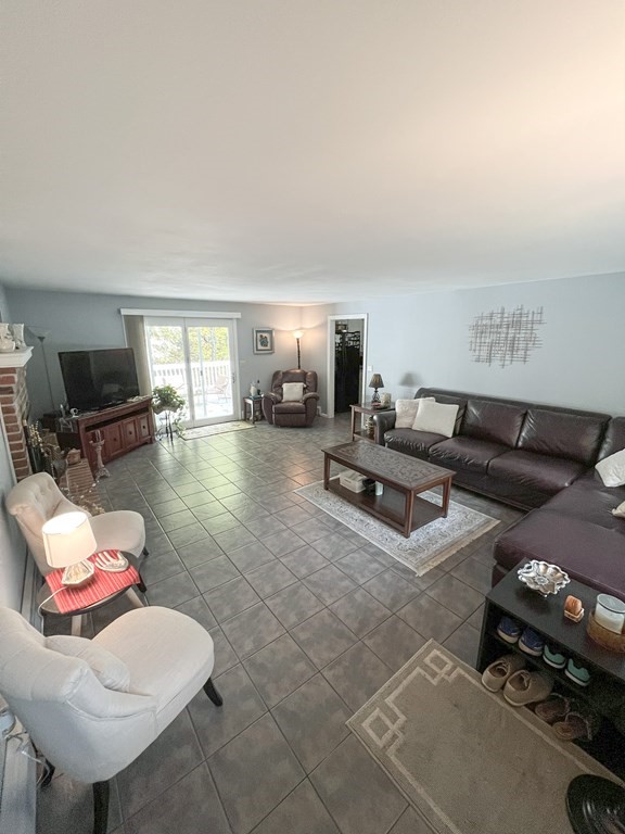 35 Robert Road Tyngsborough, MA 01879 - Photo 7 of 25 a living room with furniture and a flat screen tv