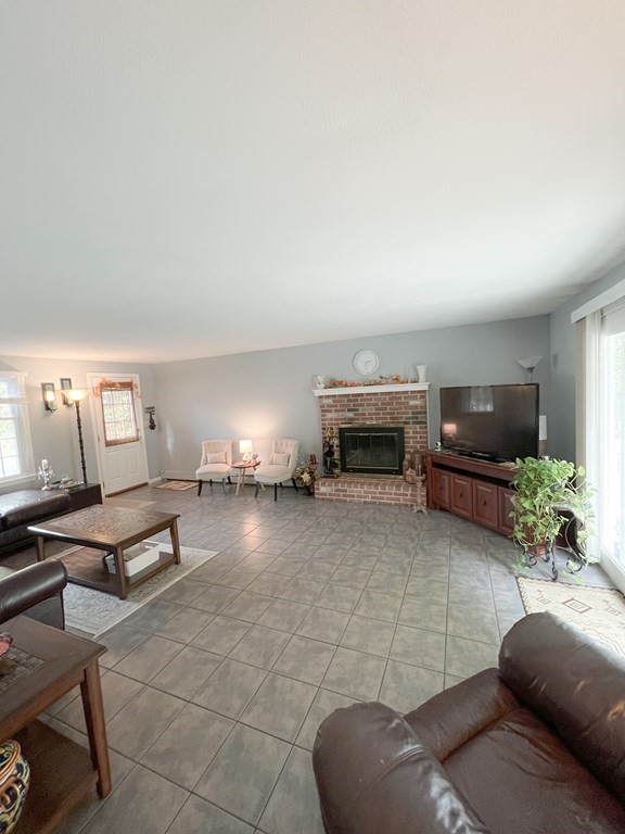 35 Robert Road Tyngsborough, MA 01879 - Photo 8 of 25 a living room with furniture and a fireplace