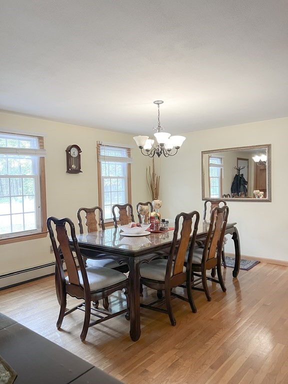 35 Robert Road Tyngsborough, MA 01879 - Photo 9 of 25 a view of a dining room with furniture a chandelier and wooden floor