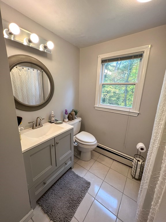 35 Robert Road Tyngsborough, MA 01879 - Photo 10 of 25 a bathroom with a toilet a sink and mirror