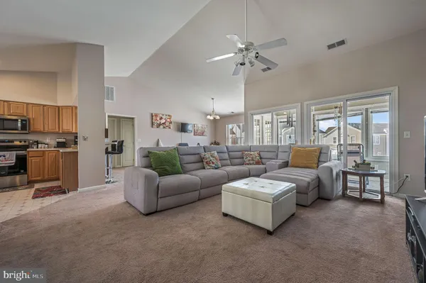 a living room with furniture and kitchen view