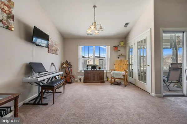 a living room with furniture a flat screen tv and a large window