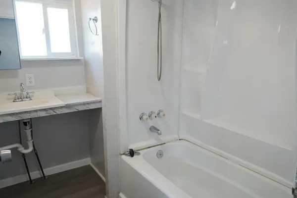 a white bath tub sitting next to a white sink