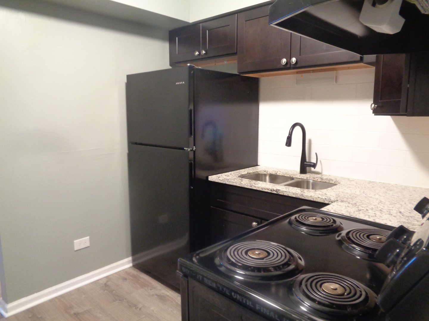 1340 North Main Street, Unit A17 Wheaton, IL 60187 - Photo 5 of 7 a kitchen with a sink and a stove