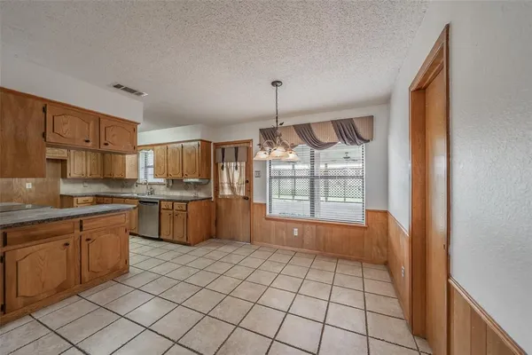 a large kitchen with lot of cabinets and stainless steel appliances