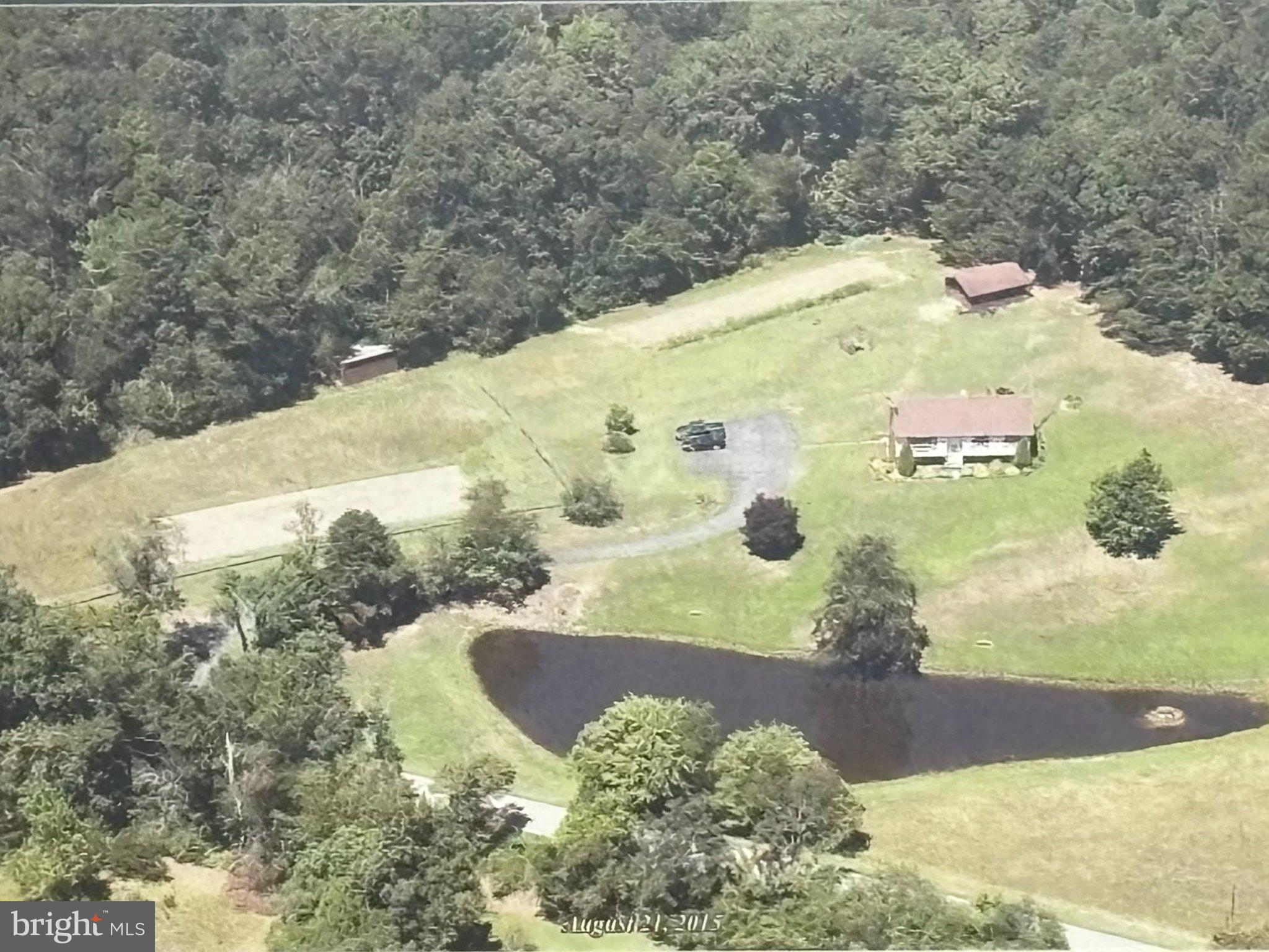 Serene countryside retreat with pond.