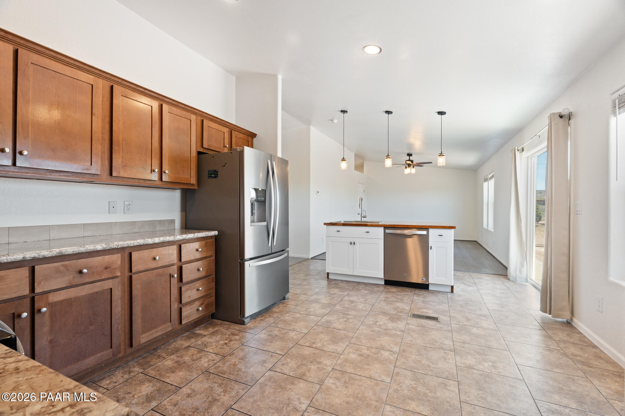 575 Ranch House Road Paulden, AZ 86334 - Photo 6 of 36 a kitchen with stainless steel appliances kitchen island granite countertop a refrigerator and a sink