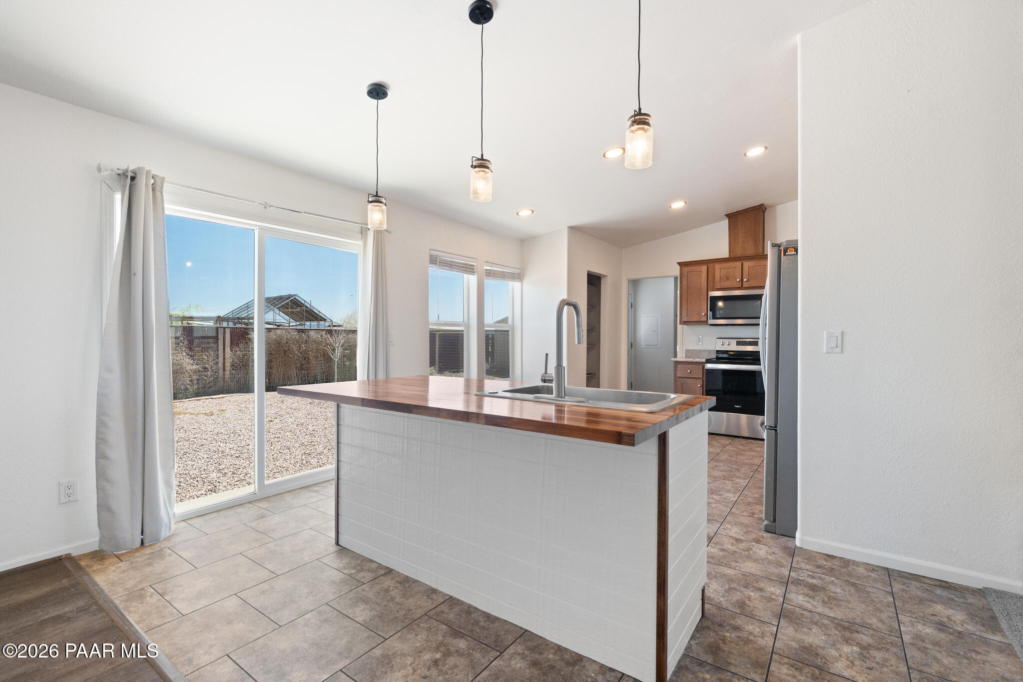 575 Ranch House Road Paulden, AZ 86334 - Photo 7 of 36 a view of a kitchen with kitchen island a counter top space appliances and a ceiling fan