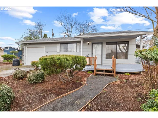 a view of a house with a patio and a garden