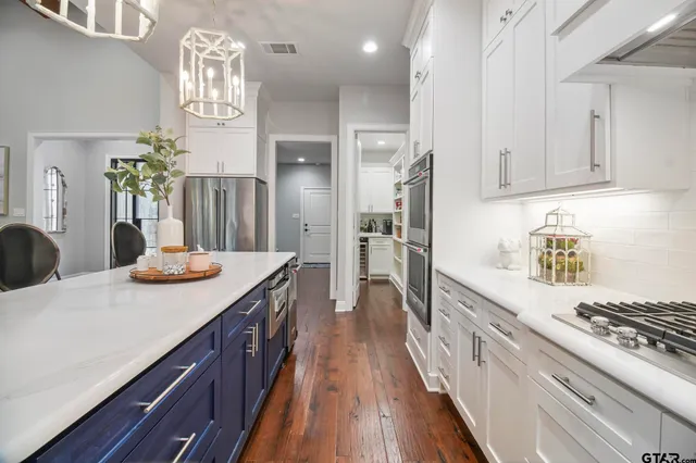 a kitchen with granite countertop a sink stove and cabinets
