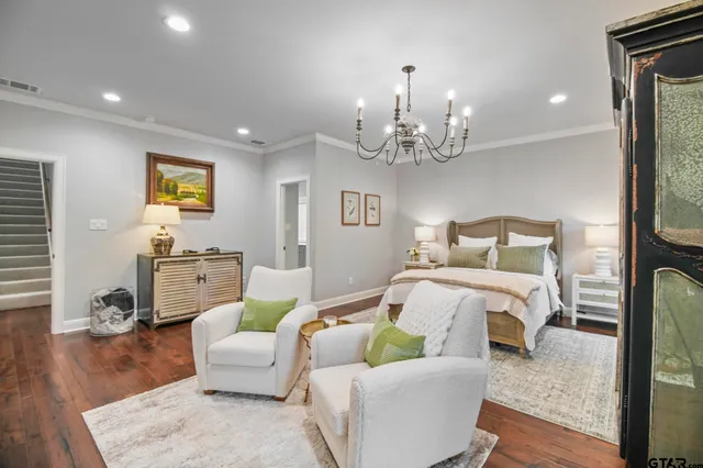 a bedroom with furniture and a chandelier