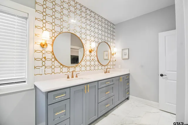 a bathroom with a double vanity sink and a mirror