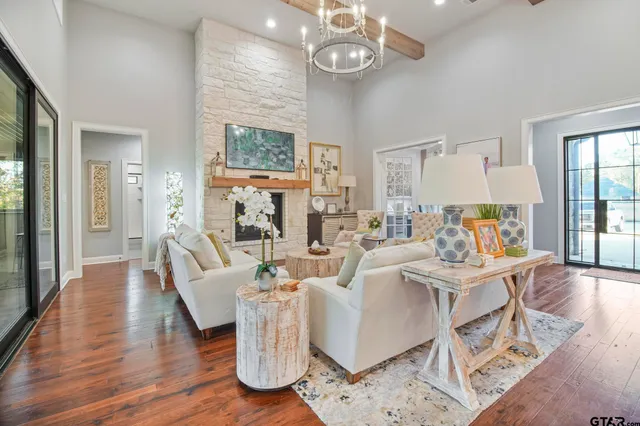 a living room with fireplace furniture and a wooden floor