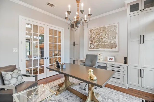a view of a dining room with furniture and chandelier