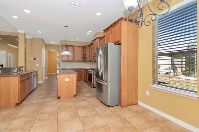 a kitchen with a refrigerator a sink and a stove
