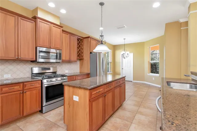 a kitchen with stainless steel appliances granite countertop a stove and a sink