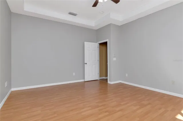 a view of an empty room with wooden floor