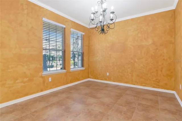 a view of empty room with chandelier