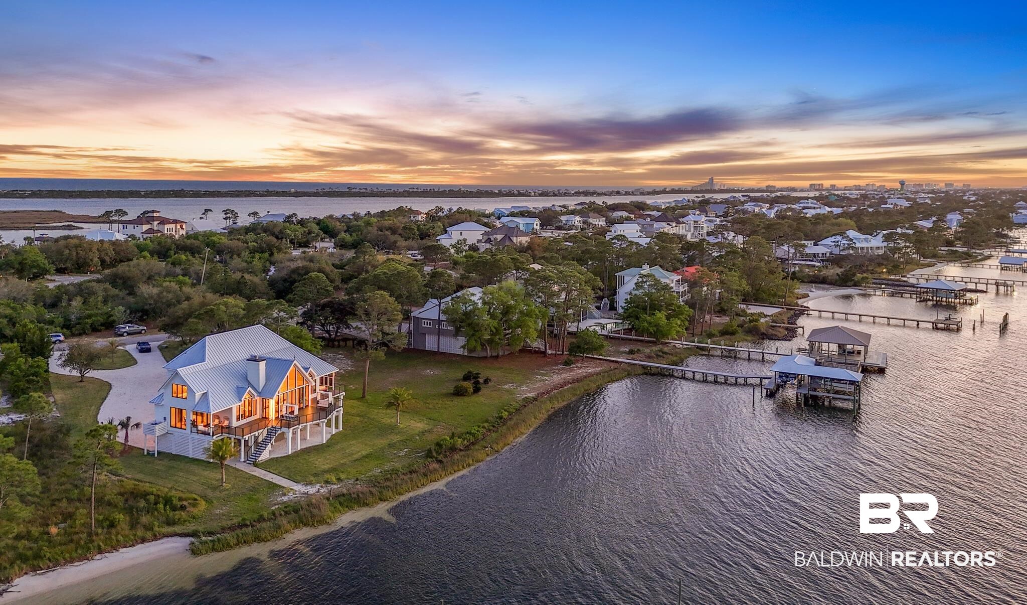 33349 River Road Orange Beach, AL 36561 - Photo 61 of 61 Waterfront property featuring a white exterior, multiple balconies, a private beach area, and a private dock with a boat lift