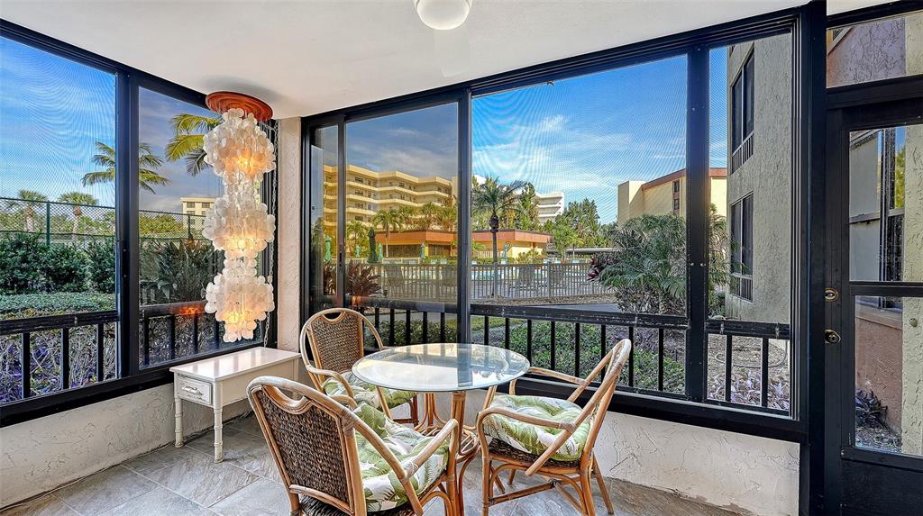 8773 Midnight Pass Road, Unit 102G Sarasota, FL 34242 - Photo 11 of 79 a view of a city from a dining room with large windows