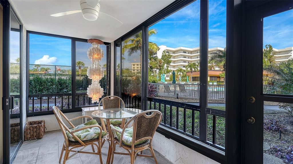 8773 Midnight Pass Road, Unit 102G Sarasota, FL 34242 - Photo 12 of 79 a view of a city from a dining room with large windows