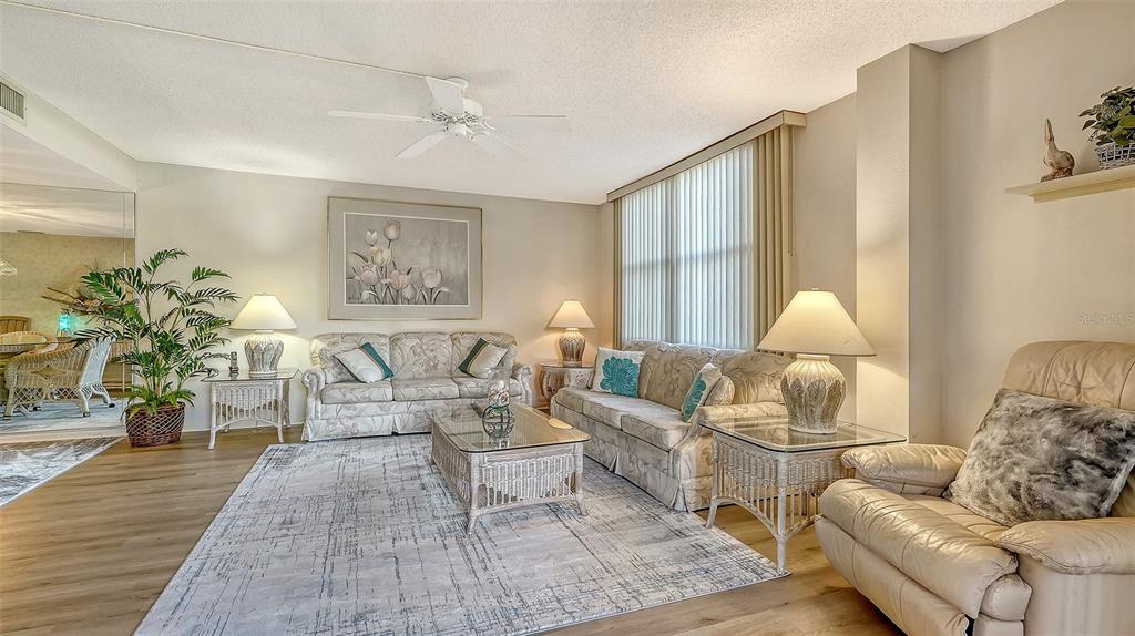 8773 Midnight Pass Road, Unit 102G Sarasota, FL 34242 - Photo 13 of 79 a living room with furniture and a lamp