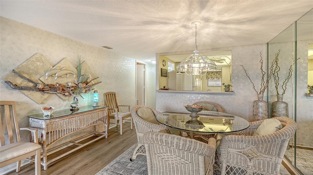 8773 Midnight Pass Road, Unit 102G Sarasota, FL 34242 - Photo 16 of 79 a view of a livingroom with furniture window and wooden floor