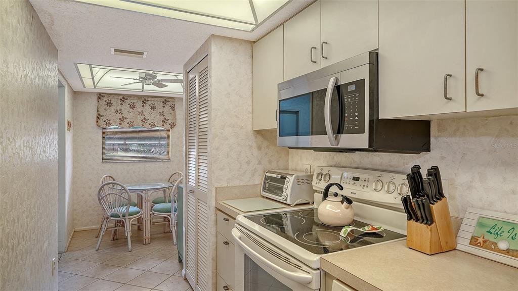8773 Midnight Pass Road, Unit 102G Sarasota, FL 34242 - Photo 19 of 79 a kitchen with a stove and a microwave
