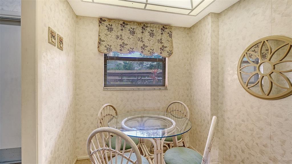 8773 Midnight Pass Road, Unit 102G Sarasota, FL 34242 - Photo 20 of 79 a table with a stove and a painting on the wall