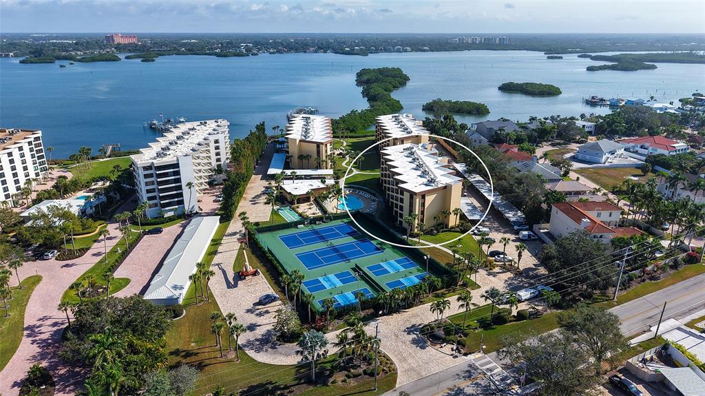 8773 Midnight Pass Road, Unit 102G Sarasota, FL 34242 - Photo 2 of 79 an aerial view of a house with a lake view