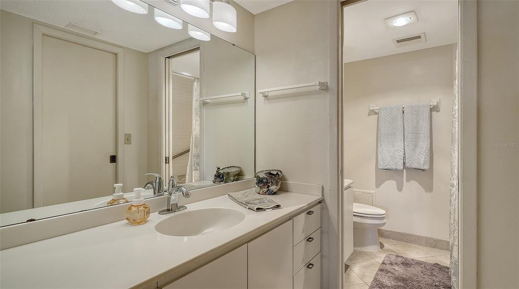 8773 Midnight Pass Road, Unit 102G Sarasota, FL 34242 - Photo 27 of 79 a bathroom with a sink toilet and shower